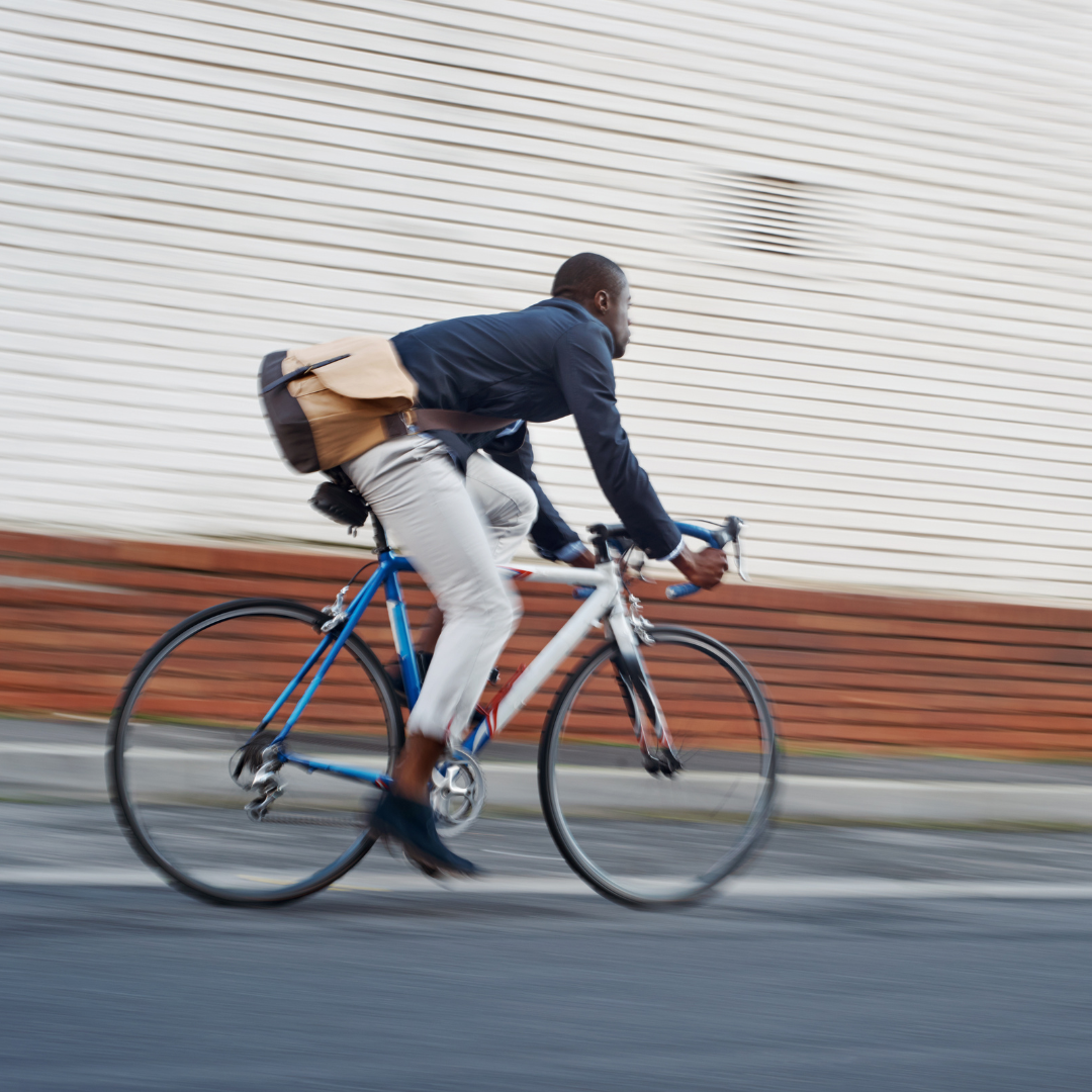 Bicyclist applying no rinse body wash after a morning commute, ready for the workday without needing a shower.