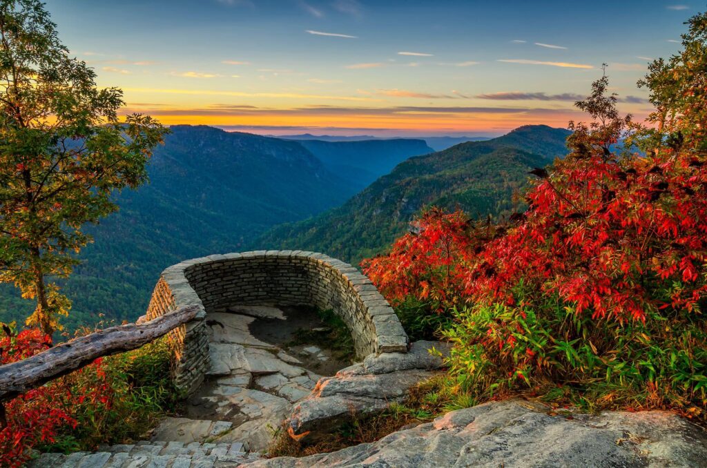 Sunset over the jagged peaks of Linville Gorge Wilderness in North Carolina, known for its challenging rock formations and trails.